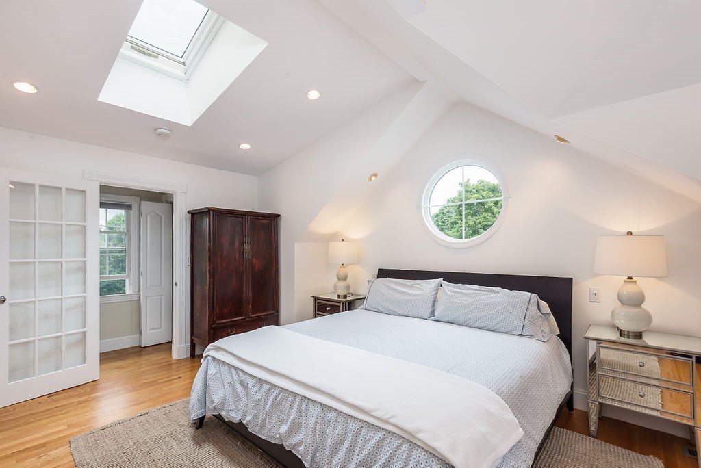 1844 Main Street, Unit 1844 Concord, MA 01742 - Photo 25 of 42 a bedroom with a bed and a window