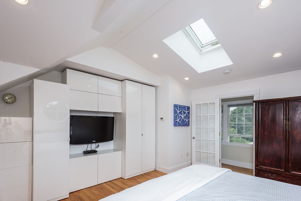 1844 Main Street, Unit 1844 Concord, MA 01742 - Photo 26 of 42 a bedroom with a bed and a flat screen tv