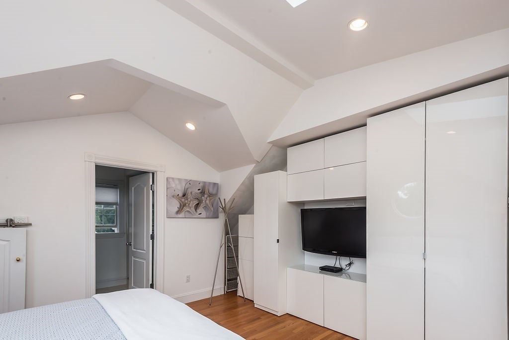 1844 Main Street, Unit 1844 Concord, MA 01742 - Photo 27 of 42 a bedroom with a bed and a television