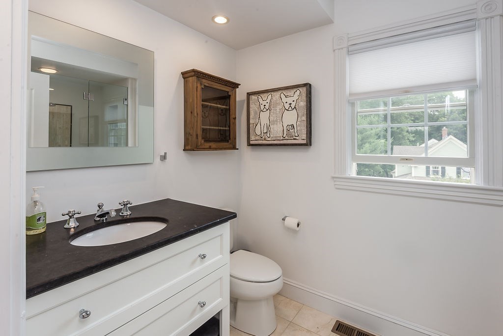 1844 Main Street, Unit 1844 Concord, MA 01742 - Photo 28 of 42 a bathroom with a sink a toilet and mirror
