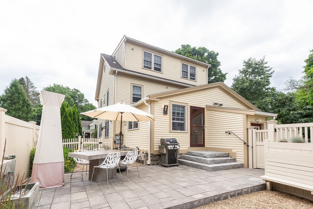 1844 Main Street, Unit 1844 Concord, MA 01742 - Photo 38 of 42 a view of a white house with large windows and wooden fence