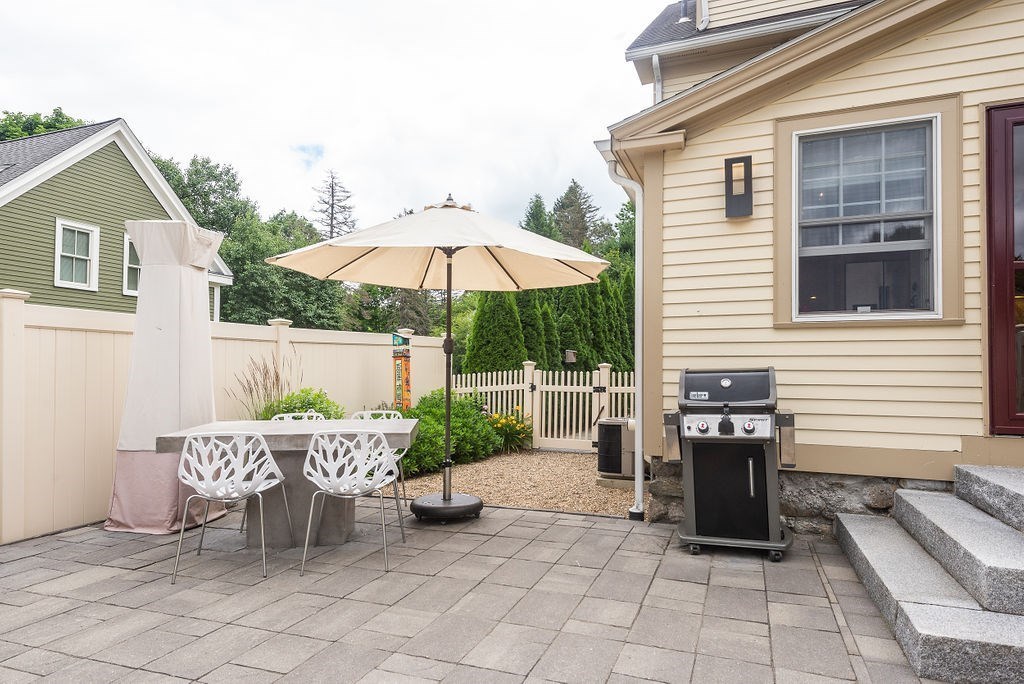 1844 Main Street, Unit 1844 Concord, MA 01742 - Photo 39 of 42 a view of a patio with a table and chairs under an umbrella