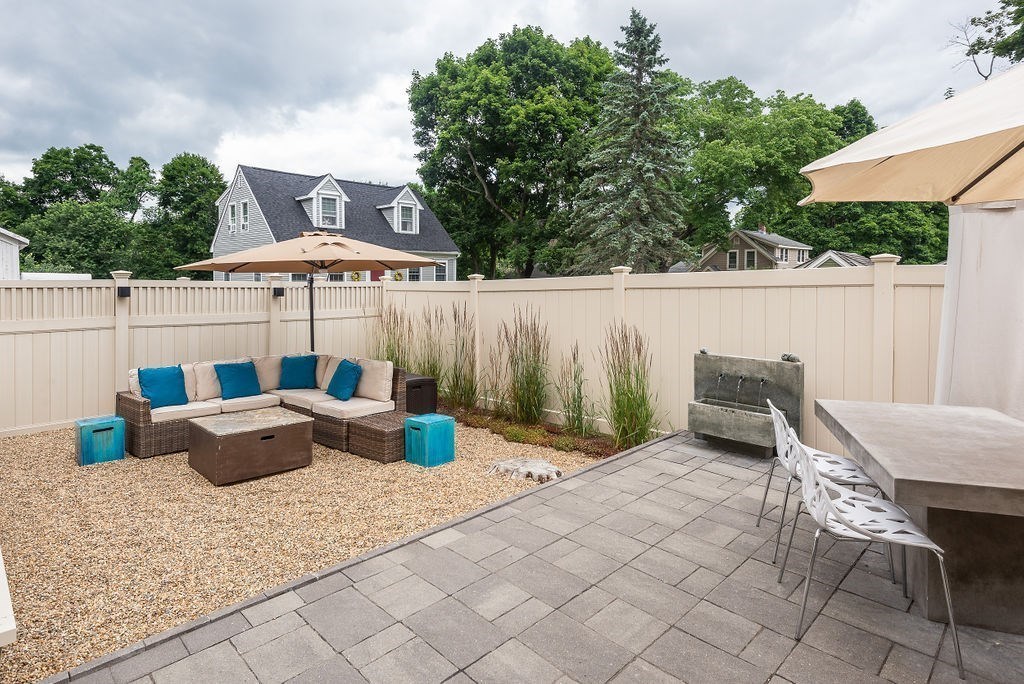 1844 Main Street, Unit 1844 Concord, MA 01742 - Photo 41 of 42 a view of outdoor sitting area with furniture and umbrella