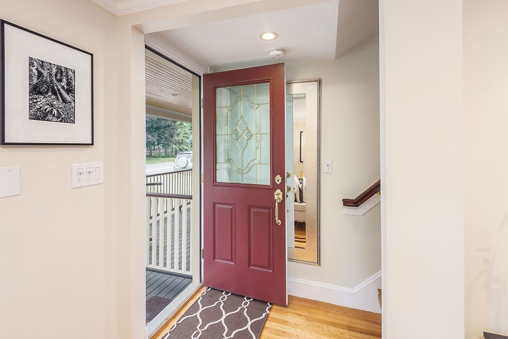 1844 Main Street, Unit 1844 Concord, MA 01742 - Photo 5 of 42 a view of a hallway with wooden floor and furniture