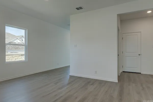 a open kitchen with kitchen island a sink dishwasher a stove and a refrigerator with wooden floor