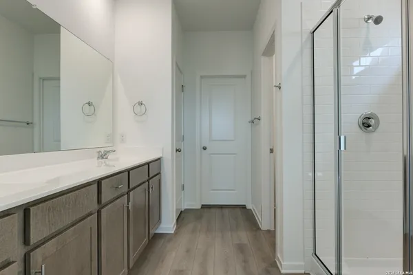 a bathroom with a sink a mirror and a shower