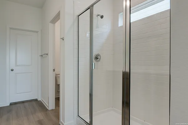 an empty room with fan and windows