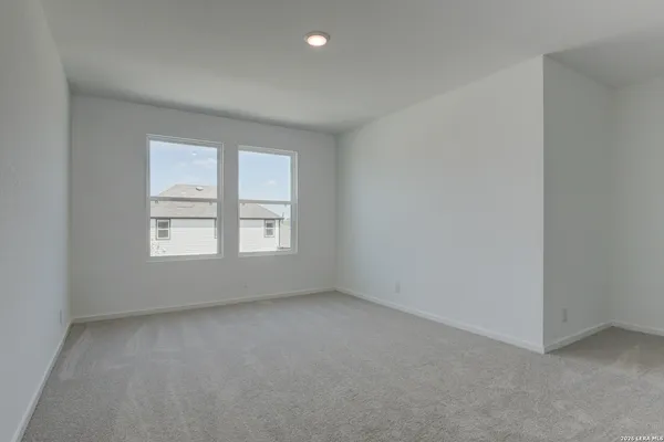 a backyard of a house with plants and wooden fence