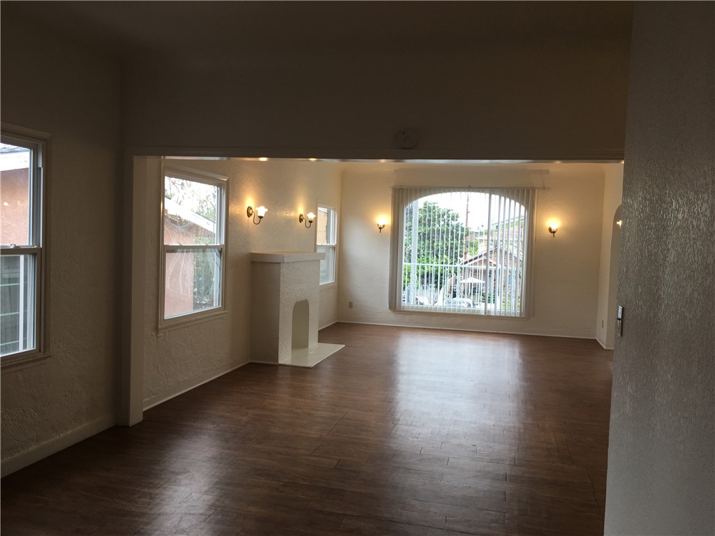 1043 Stanley Avenue Long Beach, CA 90804 - Photo 12 of 16 an empty room with wooden floor and windows