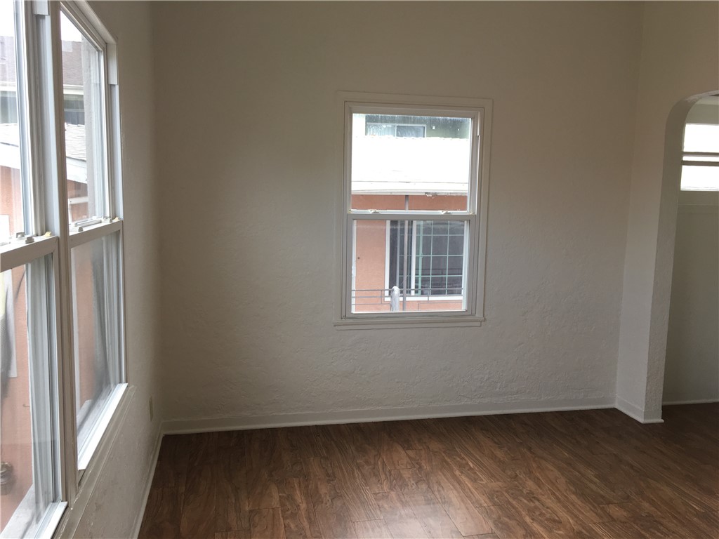 1043 Stanley Avenue Long Beach, CA 90804 - Photo 14 of 16 an empty room with wooden floor and windows