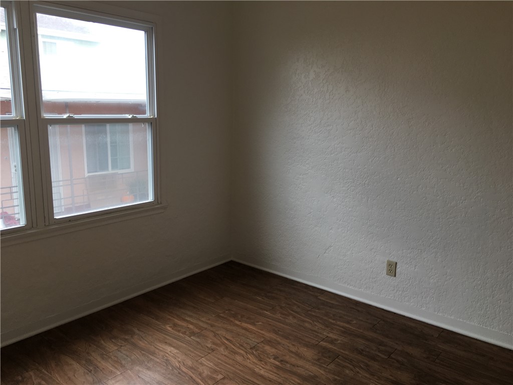 1043 Stanley Avenue Long Beach, CA 90804 - Photo 16 of 16 a view of an empty room with wooden floor and a window