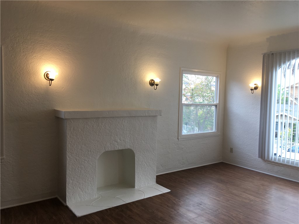1043 Stanley Avenue Long Beach, CA 90804 - Photo 3 of 16 an empty room with wooden floor cabinet and windows