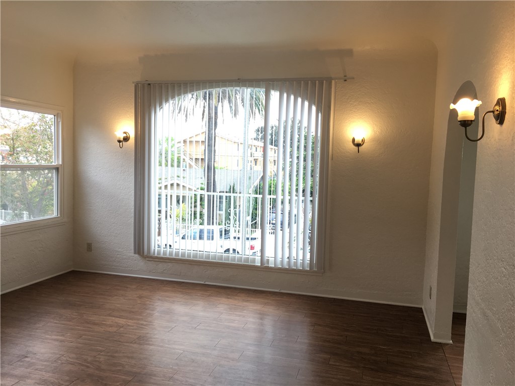 1043 Stanley Avenue Long Beach, CA 90804 - Photo 4 of 16 a view of an empty room with wooden floor and a window