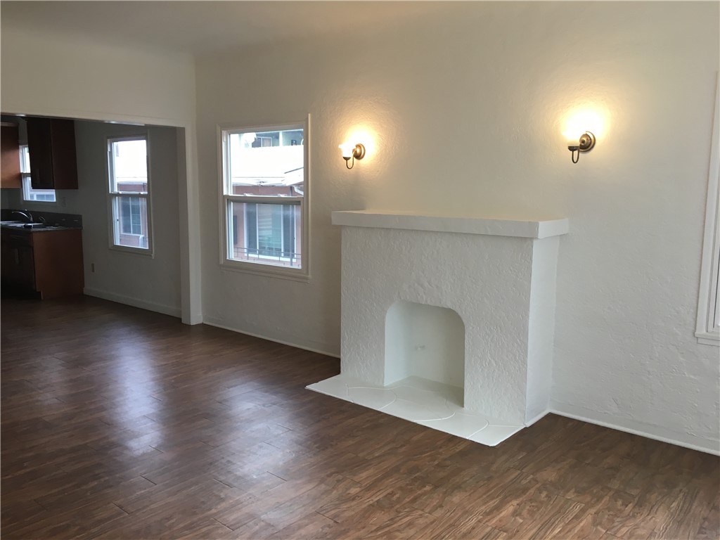 1043 Stanley Avenue Long Beach, CA 90804 - Photo 6 of 16 an empty room with wooden floor and windows