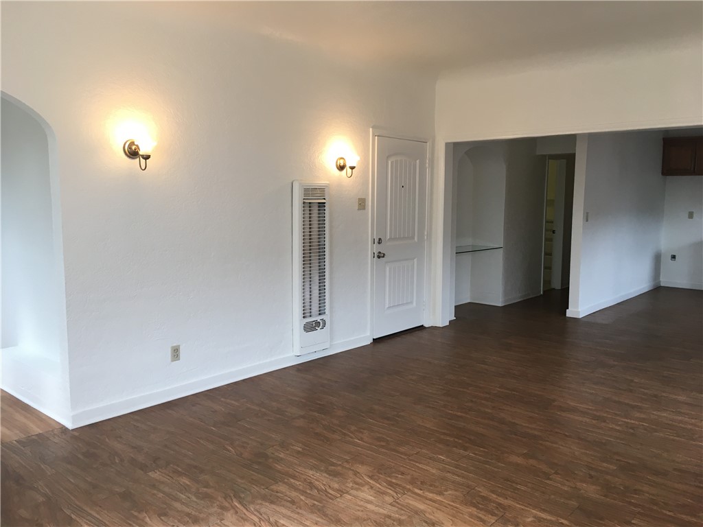 1043 Stanley Avenue Long Beach, CA 90804 - Photo 7 of 16 an empty room with wooden floor and windows