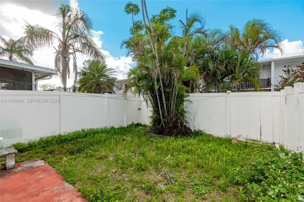 a view of a house with patio and a yard