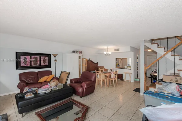 a living room with furniture a table and chairs