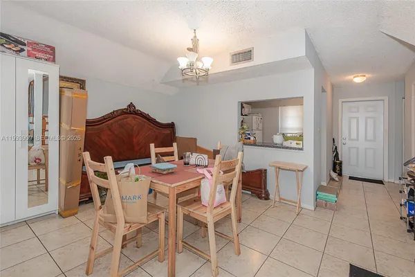 a view of a dining room with furniture and chandelier