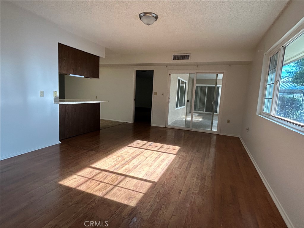 25915 Warwick Road Menifee, CA 92586 - Photo 14 of 34 wooden floor in an empty room with a window