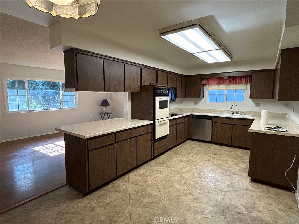 25915 Warwick Road Menifee, CA 92586 - Photo 16 of 34 a kitchen with stainless steel appliances kitchen island granite countertop a sink counter space and cabinets