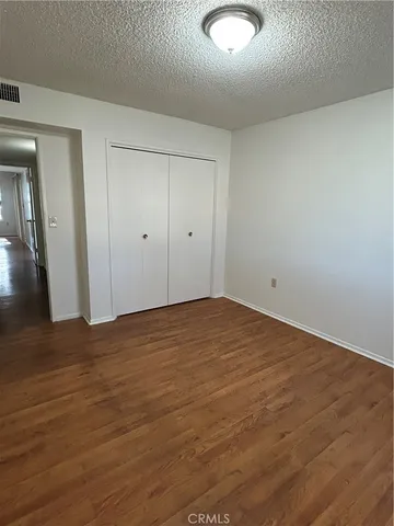 an empty room with wooden floor