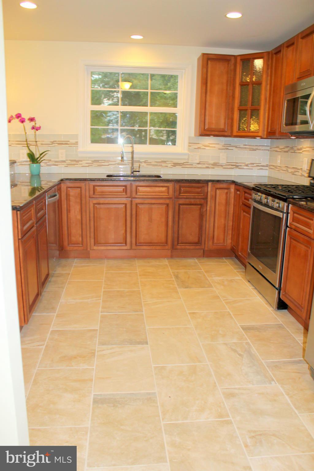 8538 Lucerne Road Randallstown, MD 21133 - Photo 4 of 16 a kitchen with stainless steel appliances granite countertop a sink and cabinets