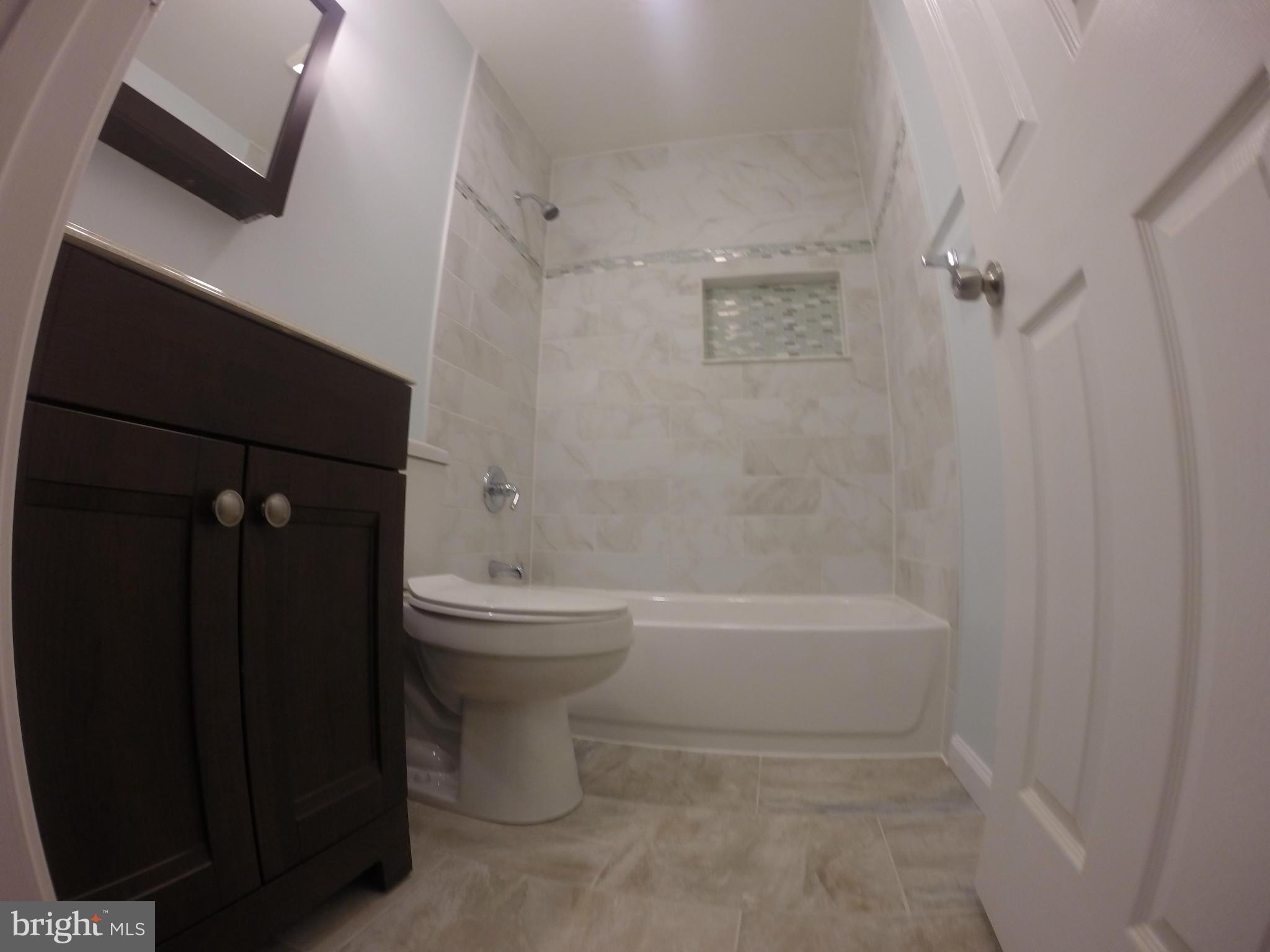 8538 Lucerne Road Randallstown, MD 21133 - Photo 8 of 16 a bathroom with a bathtub and a shower
