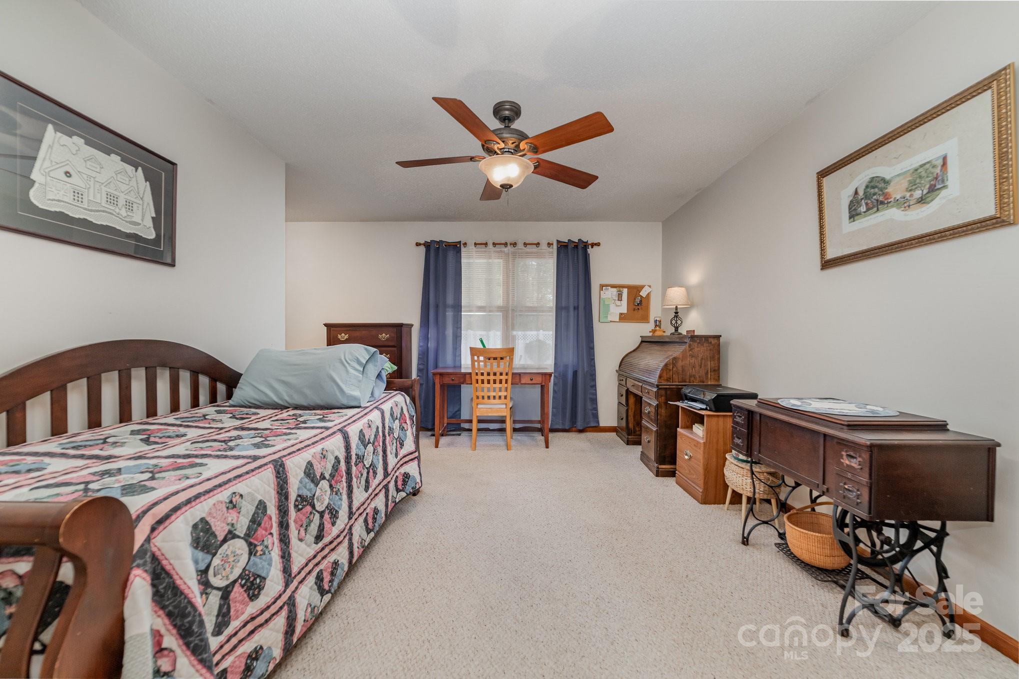 2595 Shamrock Road Harrisburg, NC 28075 - Photo 16 of 27 a bedroom with a bed and a chandelier