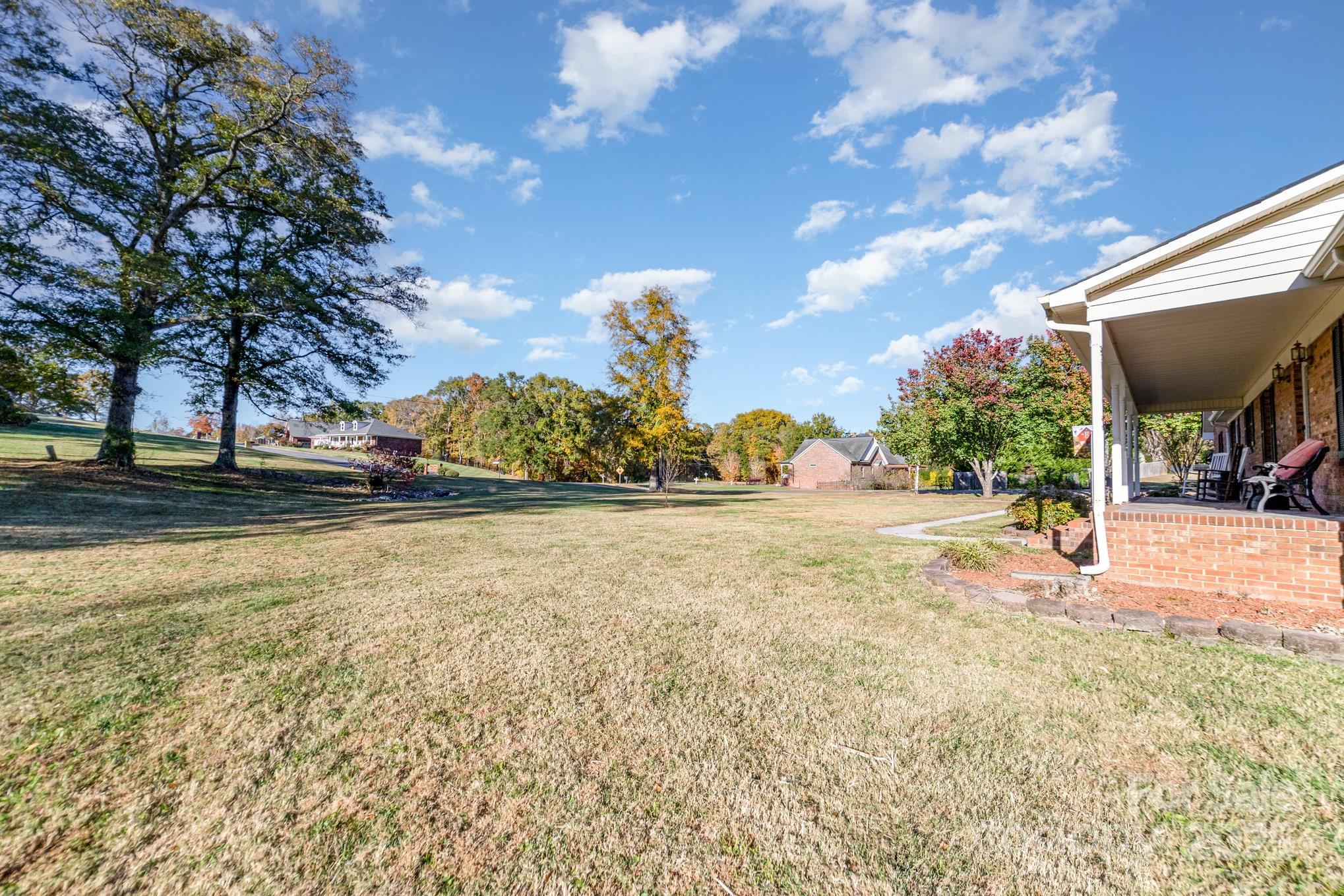 2595 Shamrock Road Harrisburg, NC 28075 - Photo 27 of 27 a view of a swimming pool with a yard