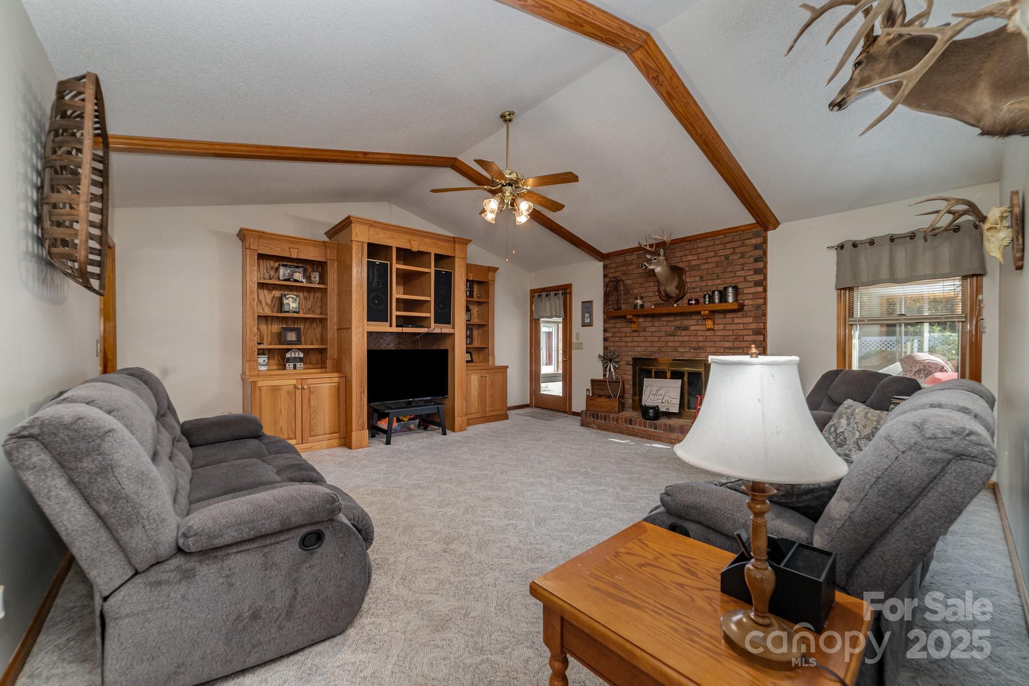 2595 Shamrock Road Harrisburg, NC 28075 - Photo 6 of 27 a living room with furniture and a fireplace