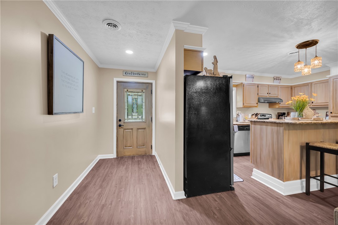 3030 Smith McGee Road Iva, SC 29655 - Photo 7 of 46 An inviting entryway leads into a spacious kitchen, featuring ample cabinetry and a functional layout.