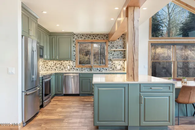 a kitchen with cabinets and oven