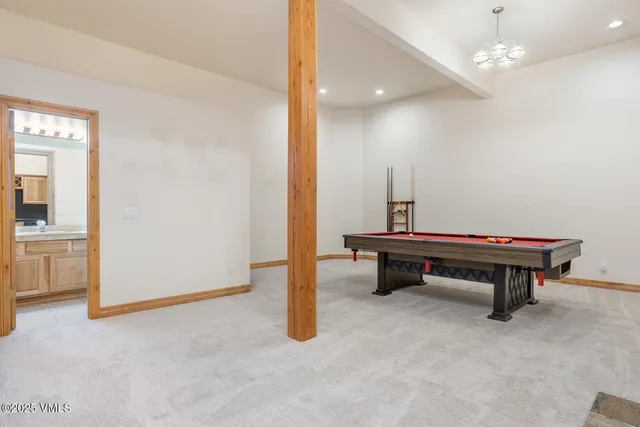 a room with stairs and pool table