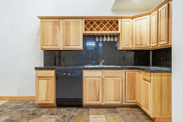 a bathroom with a granite countertop sink and a window