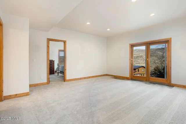 an empty room with sliding glass door and a window