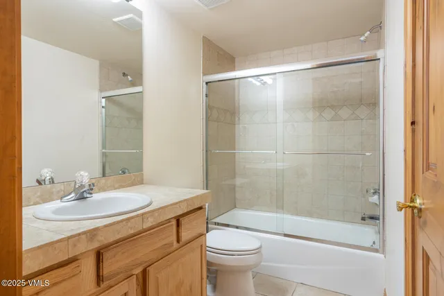 a bathroom with a sink mirror toilet and bathtub
