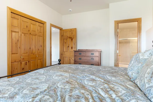 a bed room with a bed and a mirror