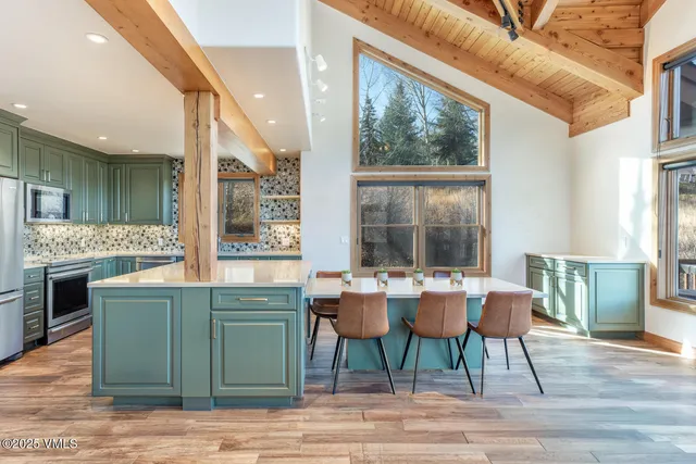 a dining room with a window and wooden floor