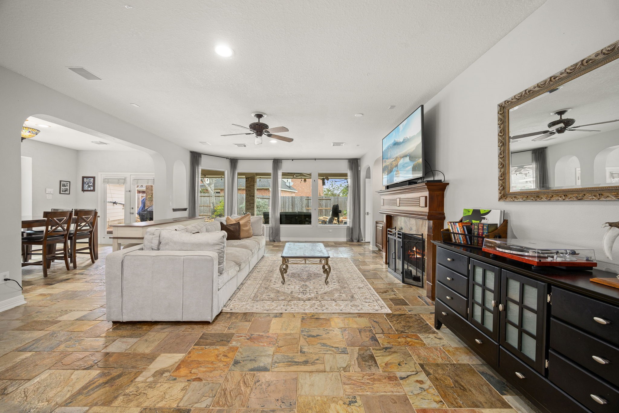 22610 Shallow Spring Court Katy, TX 77494 - Photo 13 of 45 a living room with furniture a flat screen tv and a fireplace