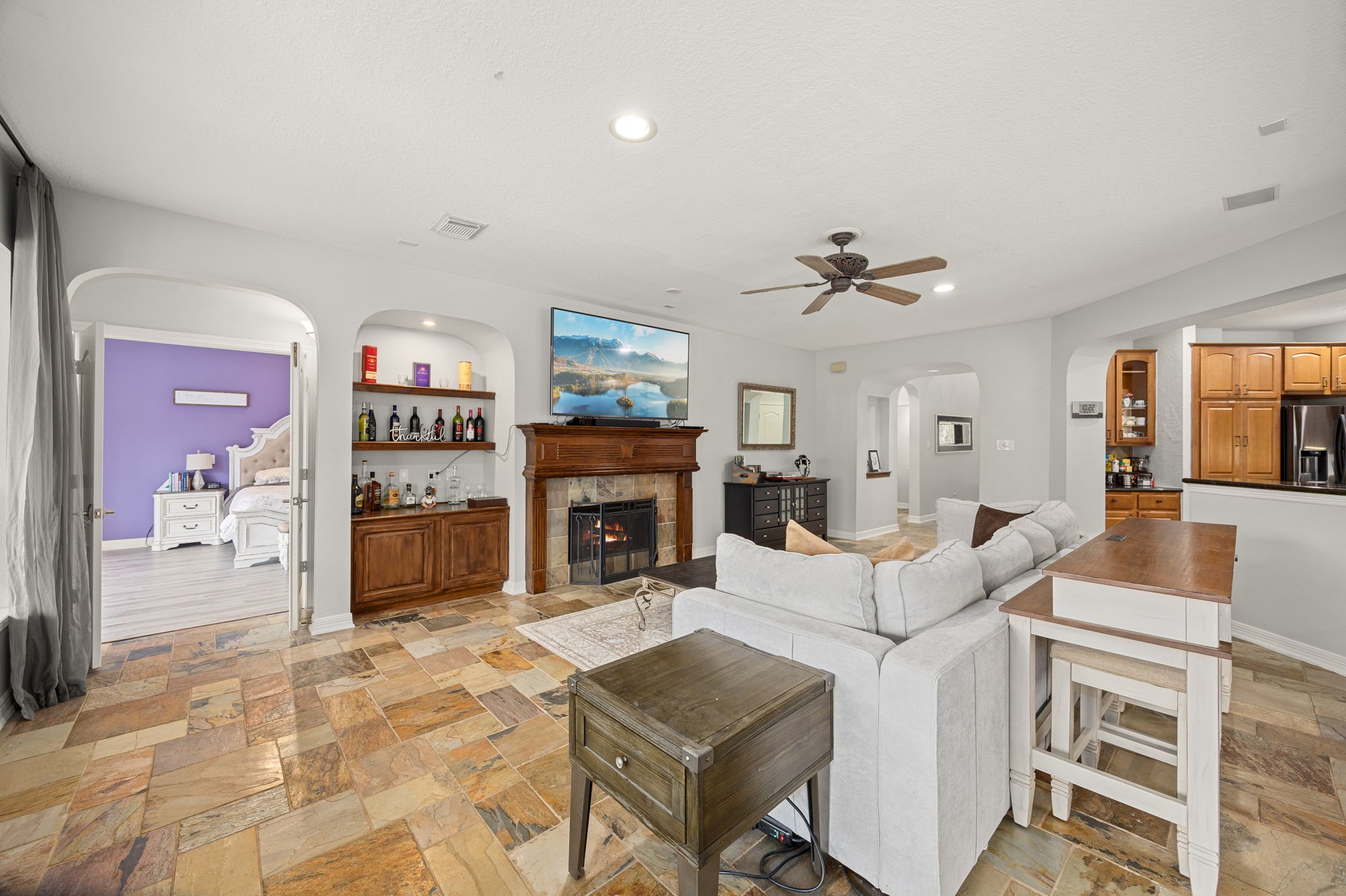 22610 Shallow Spring Court Katy, TX 77494 - Photo 14 of 45 a living room with furniture a fireplace and a flat screen tv