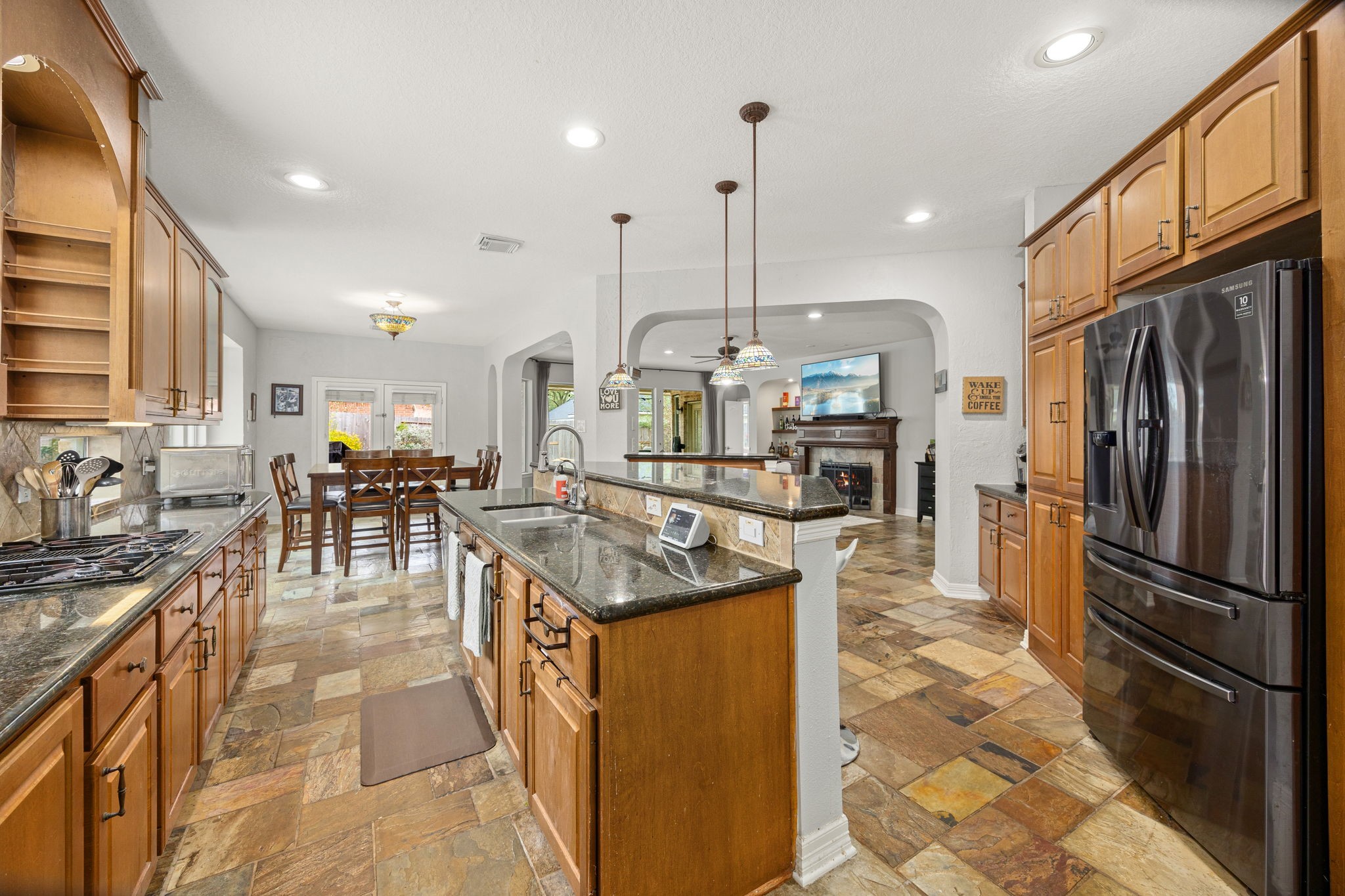 22610 Shallow Spring Court Katy, TX 77494 - Photo 7 of 45 a kitchen with stainless steel appliances granite countertop a sink a stove and a refrigerator