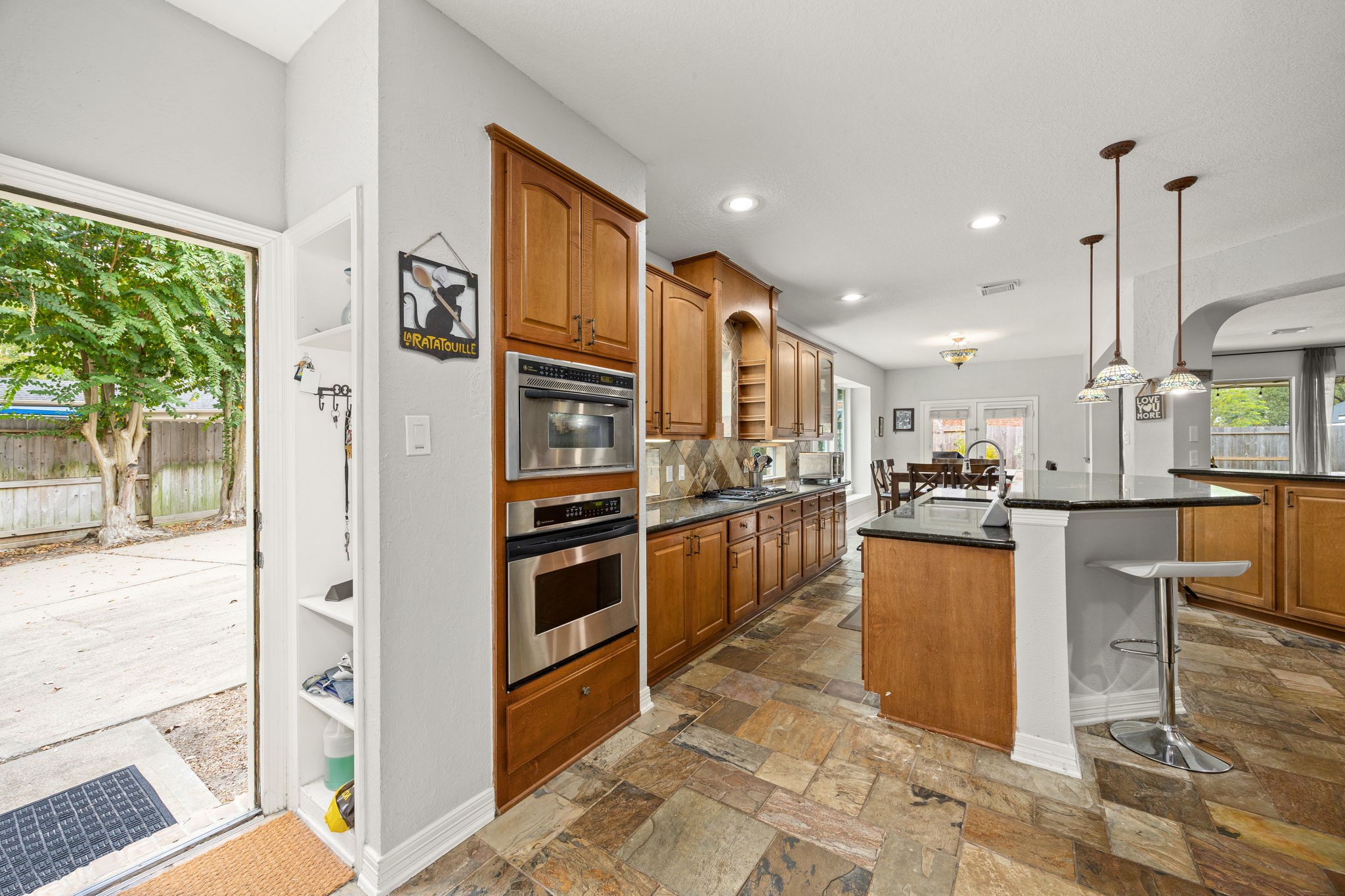 22610 Shallow Spring Court Katy, TX 77494 - Photo 10 of 45 a kitchen with stainless steel appliances kitchen island granite countertop a refrigerator and a stove top oven