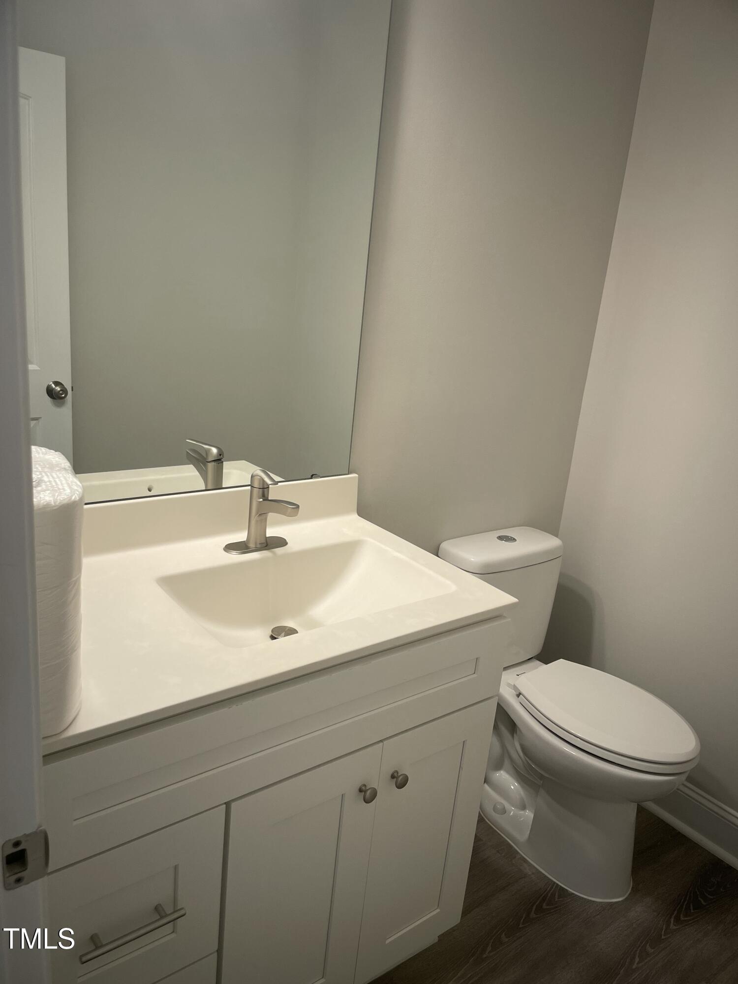 5502 Batoul Lane Raleigh, NC 27606 - Photo 12 of 35 a bathroom with a sink a toilet and mirror