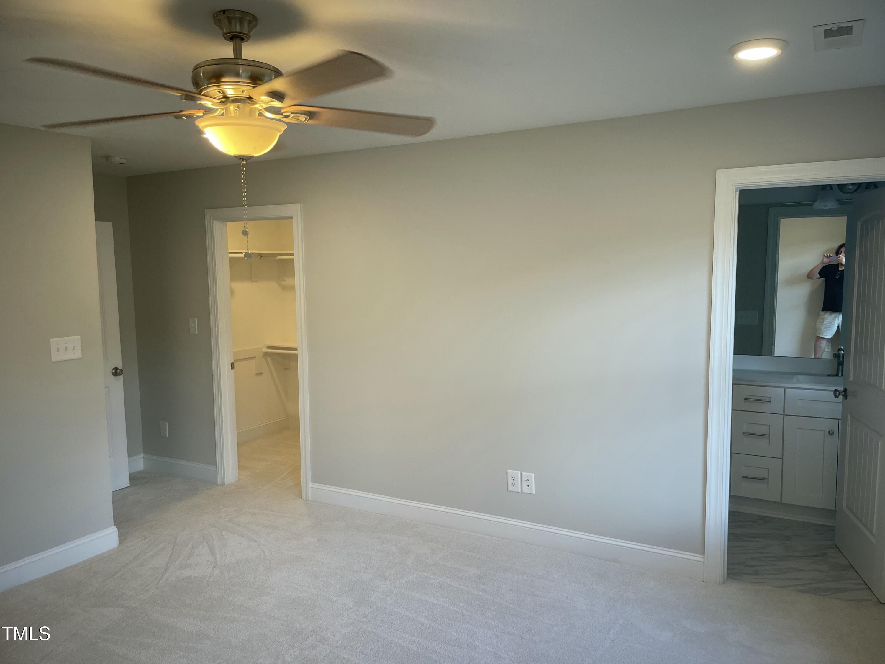 5502 Batoul Lane Raleigh, NC 27606 - Photo 19 of 35 an empty room with a bathroom and a chandelier fan