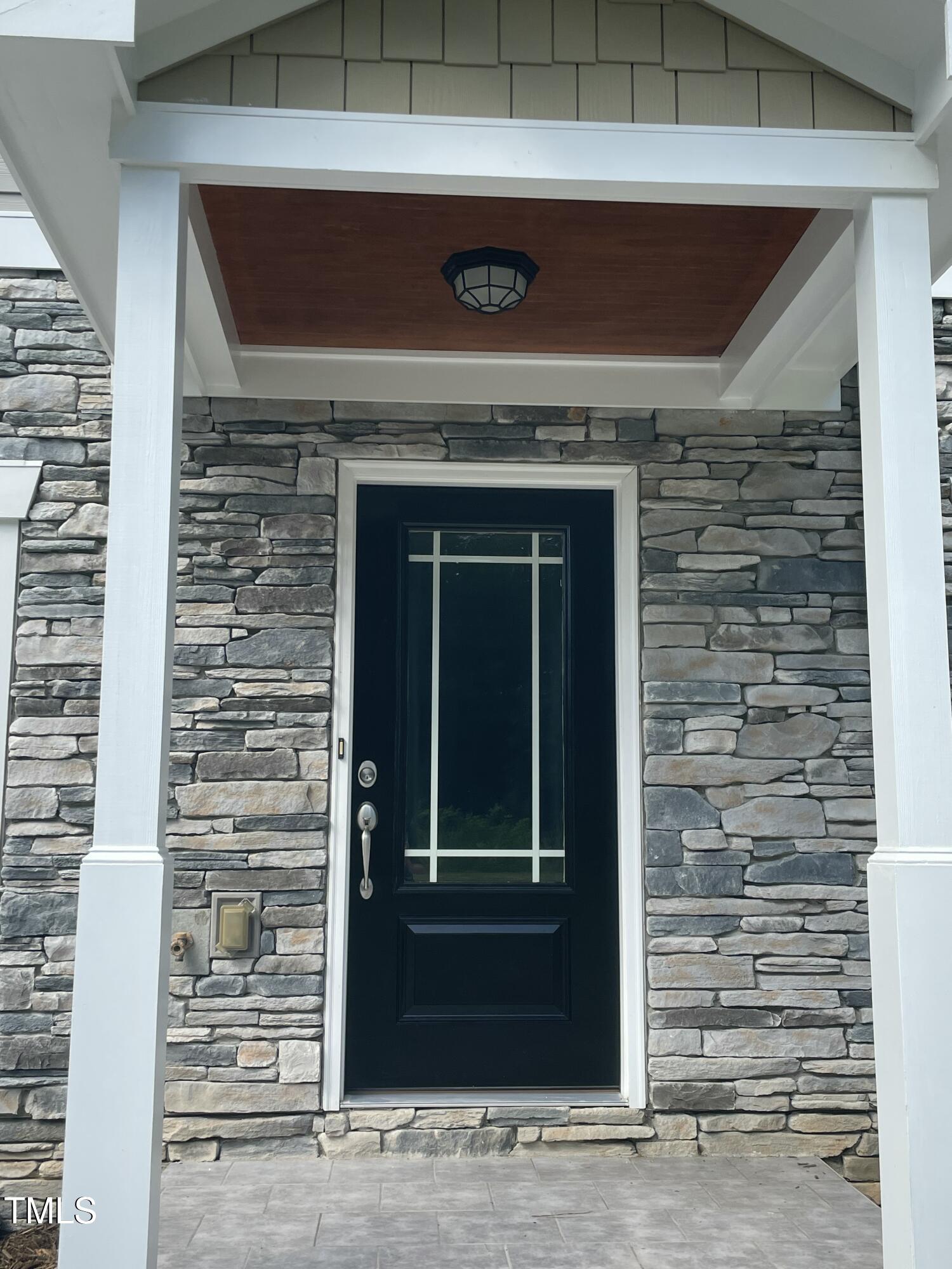 5502 Batoul Lane Raleigh, NC 27606 - Photo 2 of 35 a view of door with wooden wall