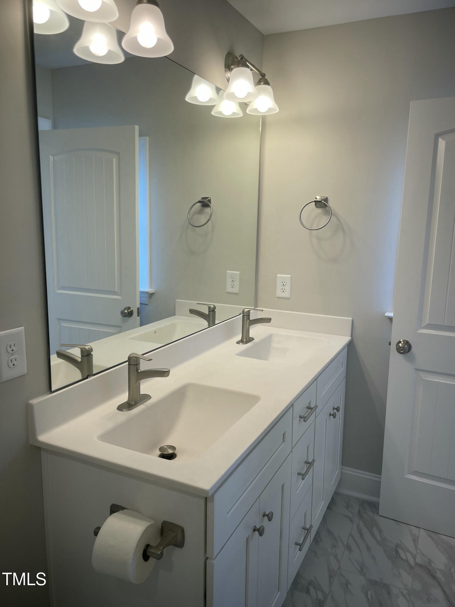 5502 Batoul Lane Raleigh, NC 27606 - Photo 21 of 35 a bathroom with a sink vanity and a mirror