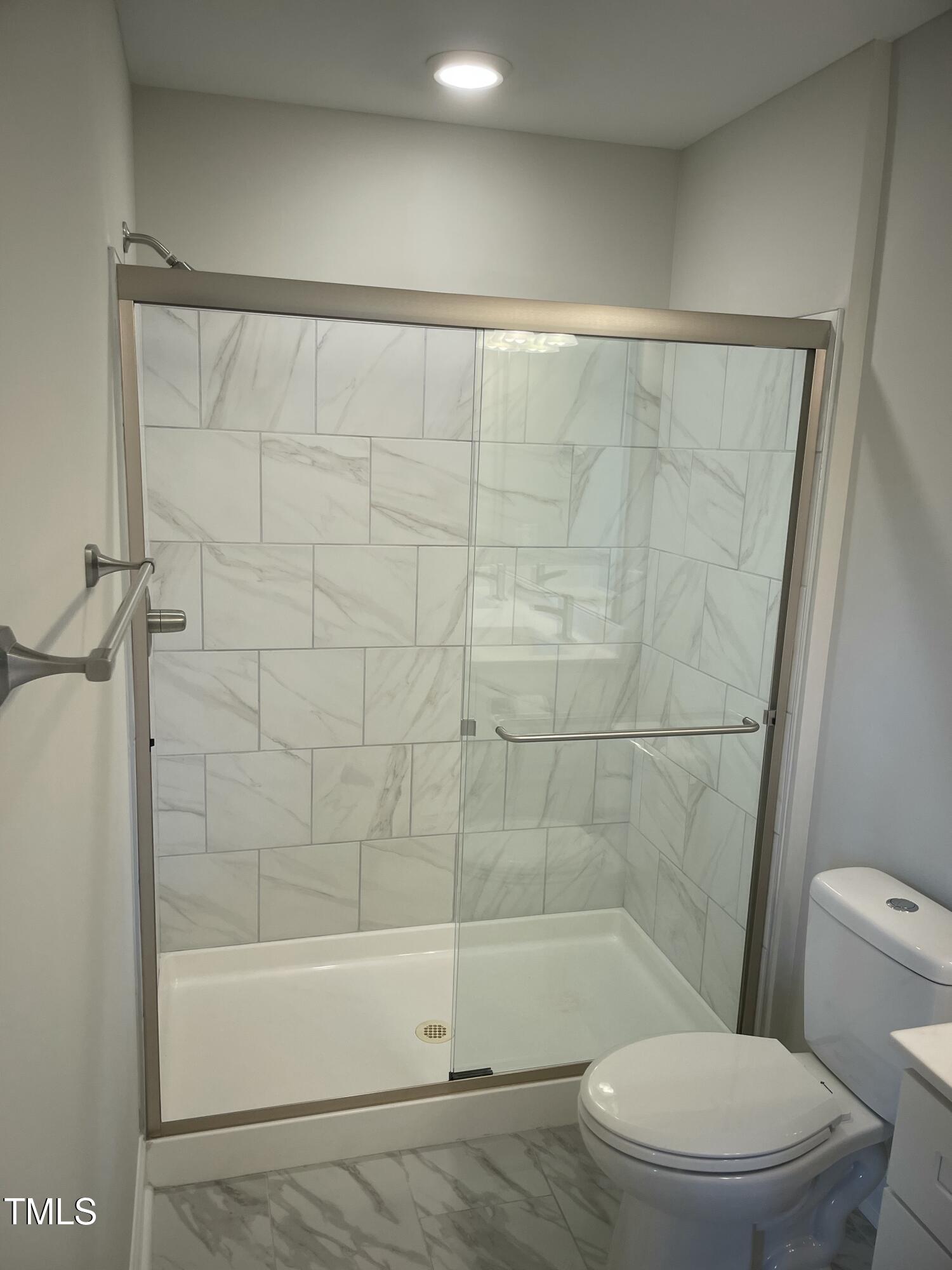 5502 Batoul Lane Raleigh, NC 27606 - Photo 22 of 35 a bathroom with a toilet and shower