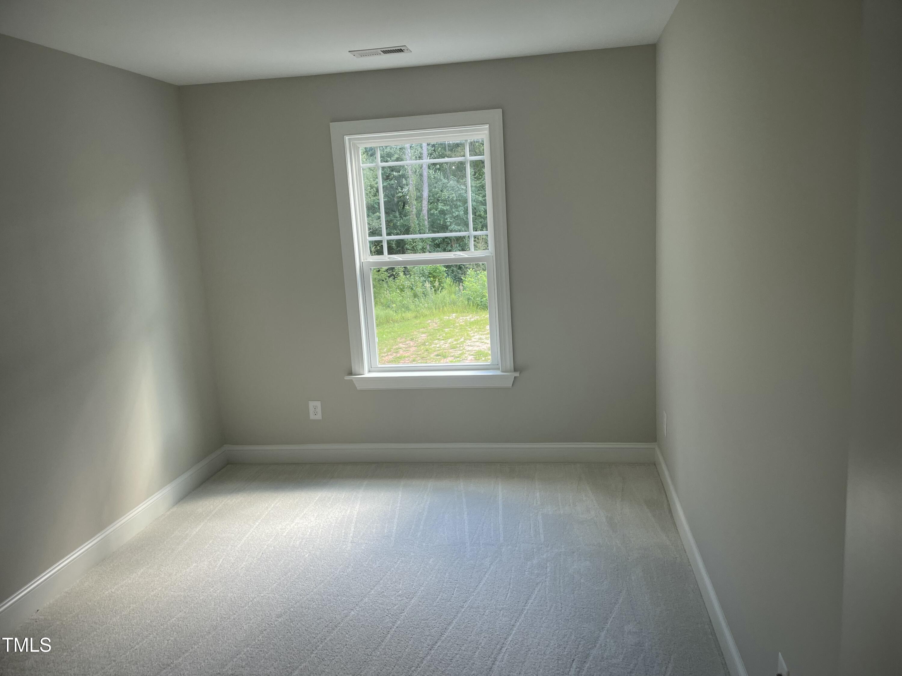 5502 Batoul Lane Raleigh, NC 27606 - Photo 27 of 35 an empty room with wooden floor and windows