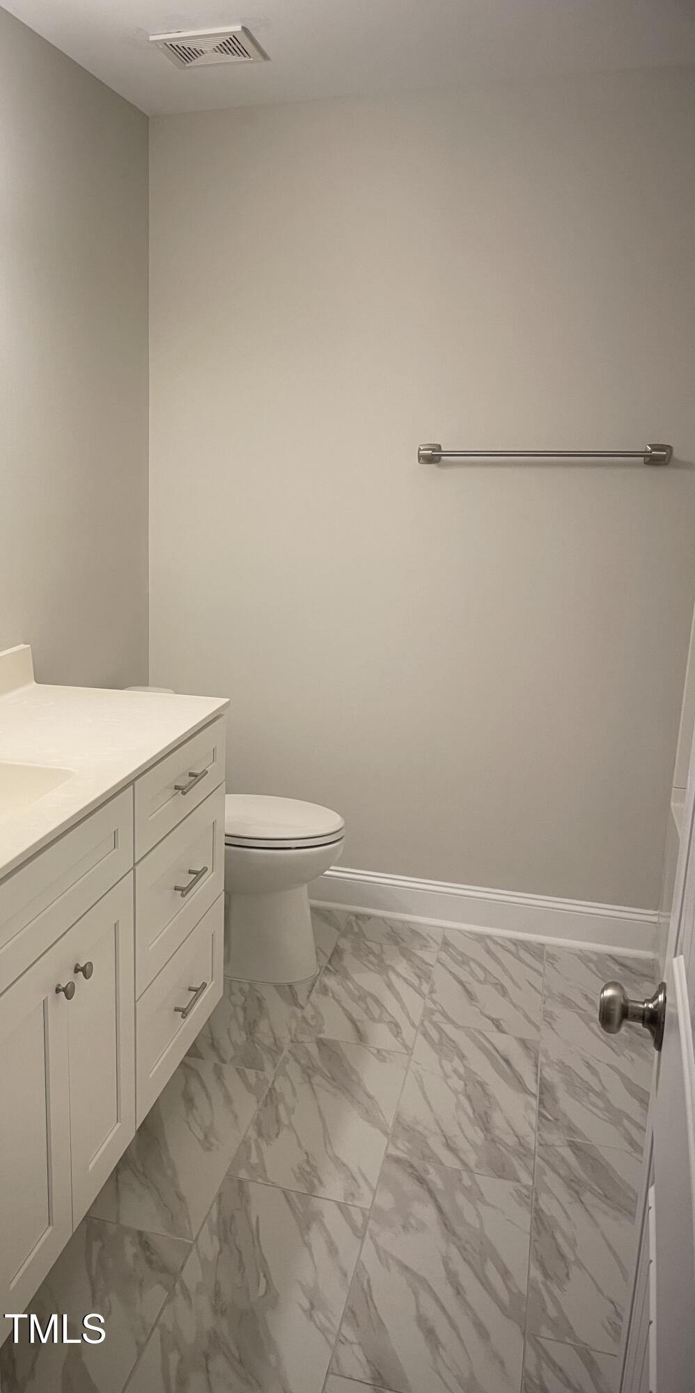 5502 Batoul Lane Raleigh, NC 27606 - Photo 33 of 35 a bathroom with a granite countertop sink a toilet and vanity