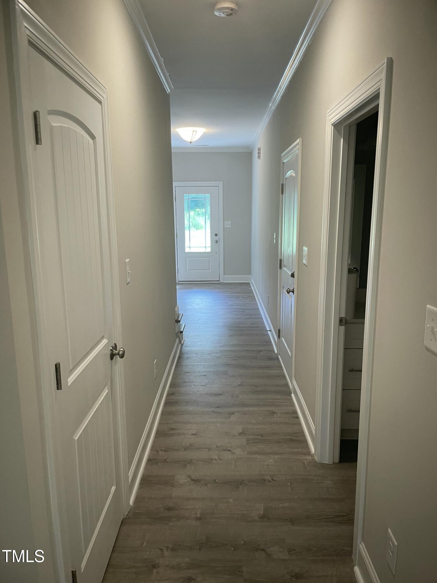 5502 Batoul Lane Raleigh, NC 27606 - Photo 5 of 35 a view of a hallway with wooden floor and closet area